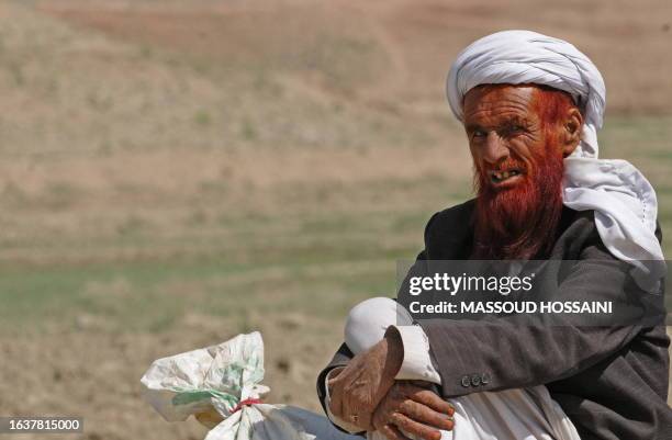 Afghanistan-unrest-aid-US-NATO,FOCUS by Charlotte McDonald-Gibson In this picture taken on April 2 an Afghan farmer talks during an interview in...