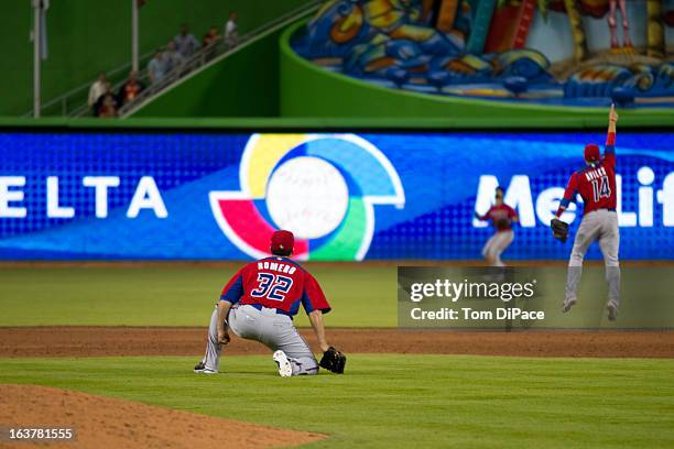 Romero of Team Puerto Rico watches Angel Pagan make the catch for the final out of Pool 2, Game 4 against Team USA in the second round of the 2013...