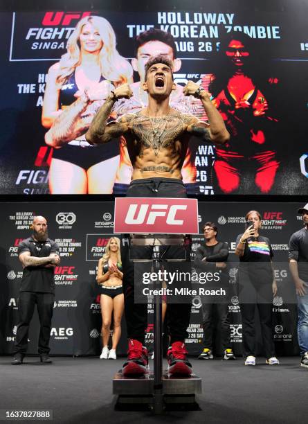 Max Holloway poses on the scale during the UFC Fight Night ceremonial weigh-in at Singapore Indoor Stadium on August 25, 2023 in Singapore.