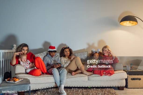 watching tv together - christmas stock pictures, royalty-free photos & images