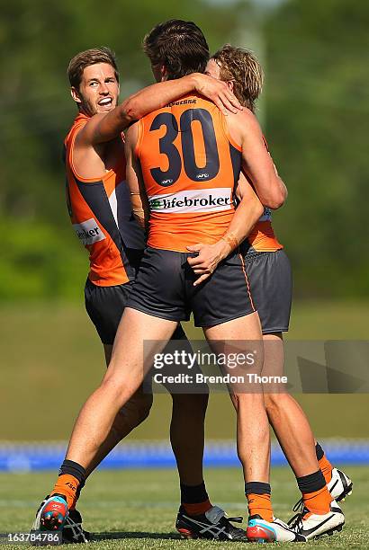 Callan Ward, Lachlan Plowman and Liam Sumner of the Giants celebrate after victory over the Saints during the AFL practice match between the Greater...
