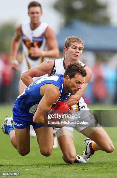 Jed Anderson of the Hawks tackles Levi Greenwood of the Kangaroos during the AFL NAB Cup match between the North Melbourne Kangaroos and the Hawthorn...