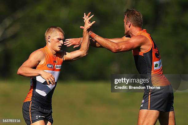 Adam Treloar of the Giants celebrates with team mate Dean Brogan after kicking a goal during the AFL practice match between the Greater Western...