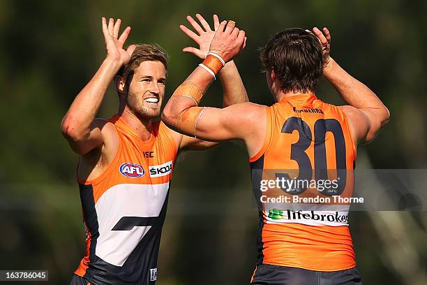 Callan Ward and Lachlan Plowman of the Giants celebrate after victory over the Saints during the AFL practice match between the Greater Western...