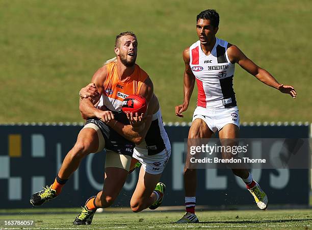 Tim Mohr of the Giants is tackled by Nick Riewoldt of the Saints during the AFL practice match between the Greater Western Sydney Giants and the St...