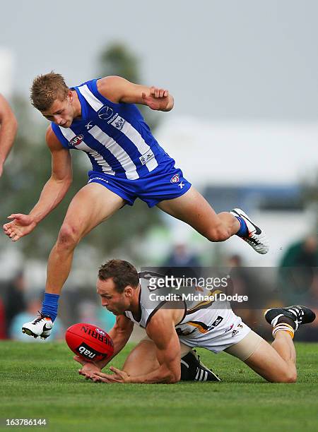 Brad Sewell of the Hawks contests for the ball against Kieran Harper of the Kangaroos during the AFL NAB Cup match between the North Melbourne...