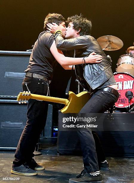 Billie Joe Armstrong kisses a fan he brought on stage as he performs in concert with Green Day at ACL Live during the South By Southwest Music...