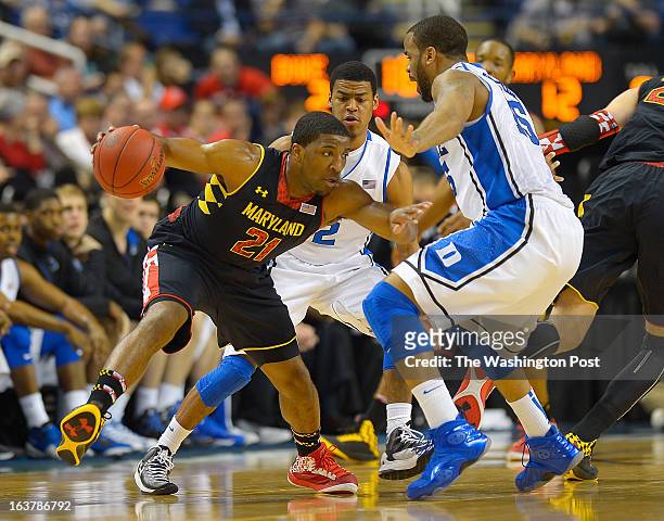 Maryland Terrapins guard Pe'Shon Howard , left, dribbles his way out of the defense of Duke guard Quinn Cook , center, and Duke forward Josh Hairston...