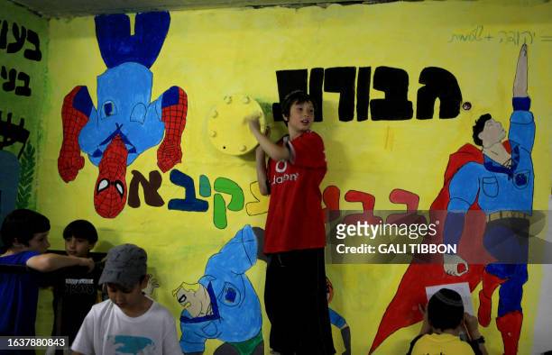 Israeli schoolchildren gather in a bomb shelter at a school in Jerusalem after sirens sounded across Israel as part of a massive civil defence...