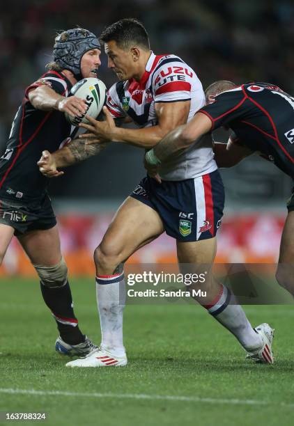Todd Lowrie of the Warriors tackles Sonny Bill Williams of the Roosters during the round two NRL match between the New Zealand Warriors and the...
