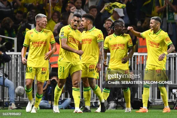 Nantes' Egyptian forward Mostafa Mohamed celebrates with teammates after scoring his team's first goal during the French L1 football match between FC...