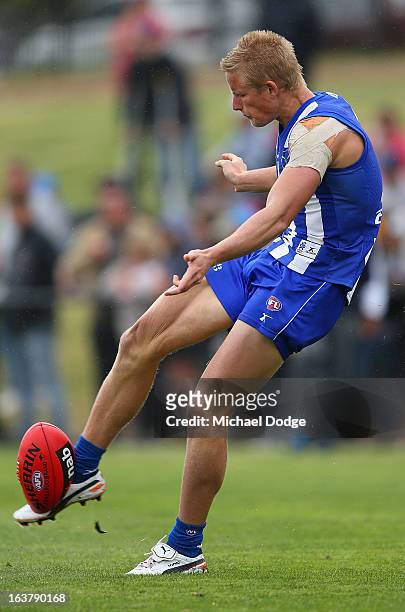 Liam Anthony of the Kangaroos kicks the ball during the AFL NAB Cup match between the North Melbourne Kangaroos and the Hawthorn Hawks at Highgate...