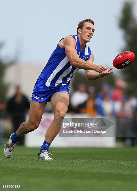 Drew Petrie of the Kangaroos handpasses the ball during the AFL NAB Cup match between the North Melbourne Kangaroos and the Hawthorn Hawks at...