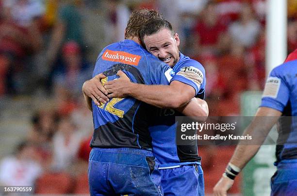 Kyle Godwin and Alby Mathewson of the Force celebrate victory during the round five Super Rugby match between the Reds and the Force at Suncorp...