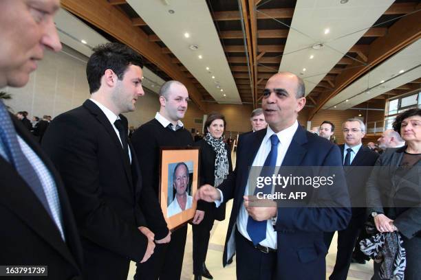 French Deputy Minister in charge of Veteran Affairs Kader Arif speaks on March 16, 2013 to unidentified relatives of Yann Desjeux a former French...