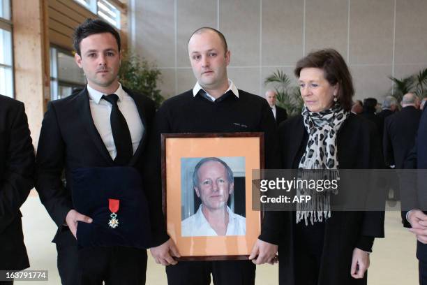 Unidentified relatives of Yann Desjeux a former French Marine Infantry paratrooper, who was killed on January 18, 2013 when the Algerian army stormed...