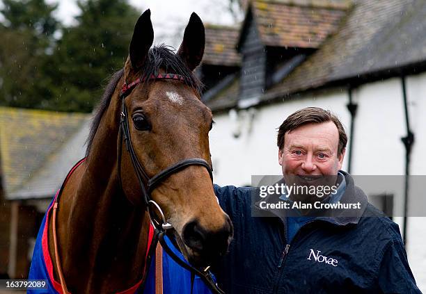 Nicky Henderson poses with Cheltenham Gold Cup winner Bobs Worth at Seven Barrows Stables on March 16, 2013 in Lambourn, England.