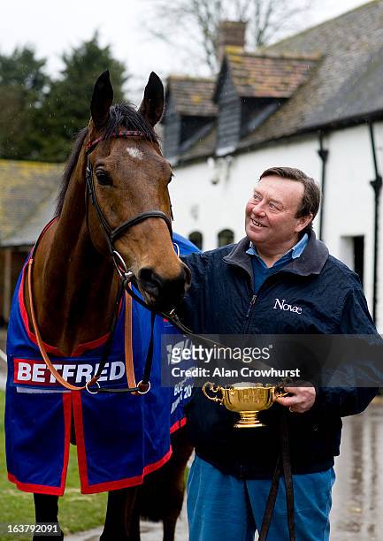 Nicky Henderson poses with Cheltenham Gold Cup winner Bobs Worth at Seven Barrows Stables on March 16, 2013 in Lambourn, England.