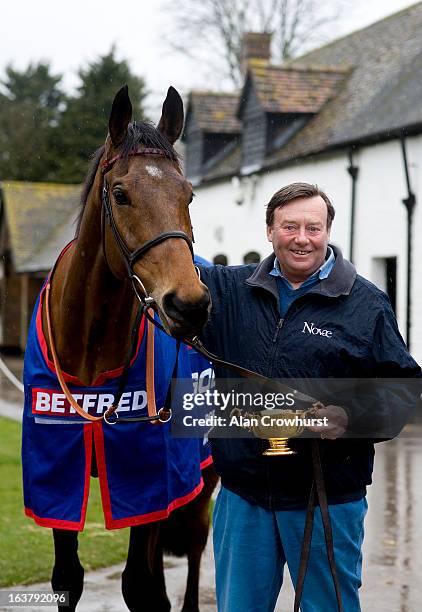 Nicky Henderson poses with Cheltenham Gold Cup winner Bobs Worth at Seven Barrows Stables on March 16, 2013 in Lambourn, England.