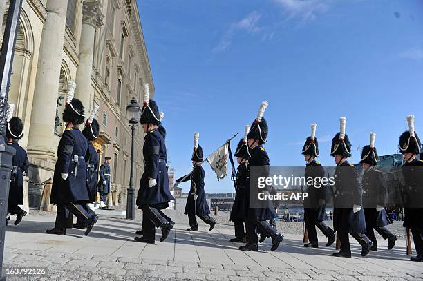 The Royal Swedish Guard march outside the Royal Palace in Stockholm, Sweden, on March 16 ahead of the funeral service for Sweden's British-born...