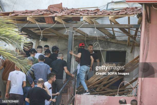 Palestinians inspect the effects of destruction near the house which was surrounded by Israeli forces during a raid to arrest Palestinians in the...