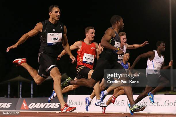 Joshua Ross of Australia and Calesio Newman of the USA compete in the mens open 100 metre race during the Perth Track Classic at the WA Athletics...