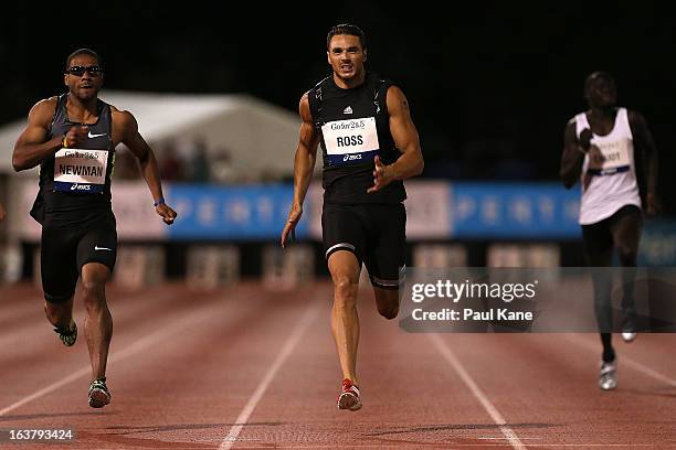 Calesio Newman of the USA and Joshua Ross of Australia compete in the mens open 200 metre race during the Perth Track Classic at the WA Athletics...