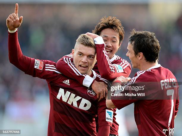 Alexander Esswein of Nuernberg celebrates with Hiroshi Kiyotake and Markus Feulner after scoring his team's second goal during the Bundesliga match...