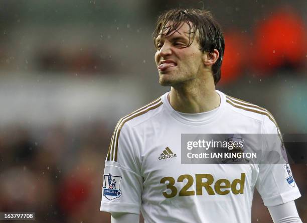 Swansea City's Spanish midfielder Miguel Michu gestures after missing a chance to score during an English Premier League football match between...