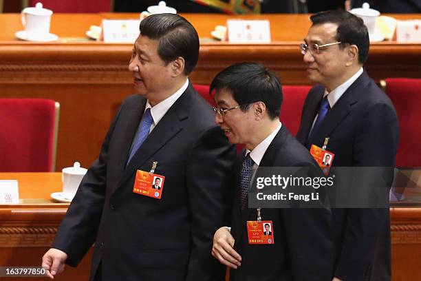 Member of the Political Bureau of the CPC Central Committee Wang Huning follows Chinese President Xi Jinping as Premier Li Keqiang looks on after the...