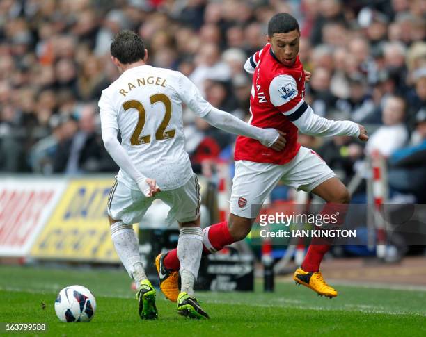 Swansea City's Spanish defender Angel Rangel vies with Arsenal's English striker Alex Oxlade-Chamberlain during an English Premier League football...