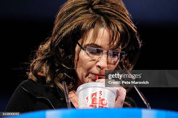 Sarah Palin, former Governor of Alaska, drinks from a large soda as she speaks about New York City Mayor Michael Bloomberg's proposed large soda ban,...