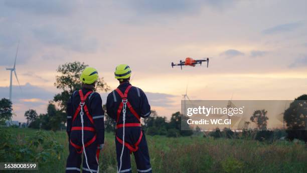 the maintenance engineer checks wind turbine blades by drone - drone pilot stock pictures, royalty-free photos & images