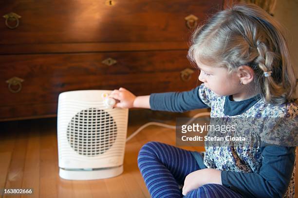 turning the heater off - electric heater stock pictures, royalty-free photos & images