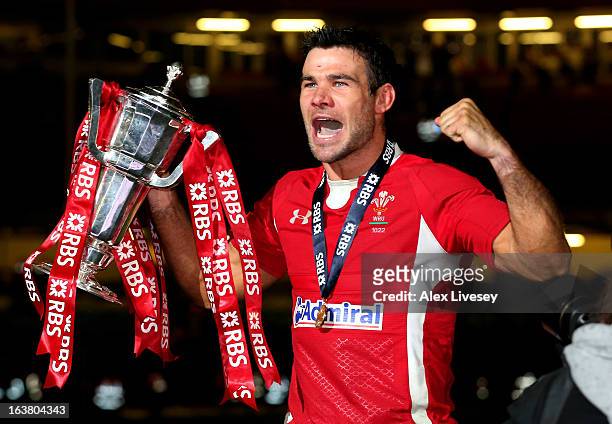 Scrumhalf Mike Phillips of Wales celebrates with the Six Nations Trophy following his team's victory during the RBS Six Nations match between Wales...