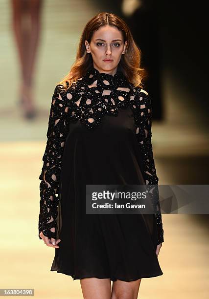 Model walks the runway during the Best of Mercedes-Benz Fashion Week Istanbul Fall/Winter 2013/14 at Antrepo 3 on March 16, 2013 in Istanbul, Turkey.