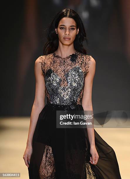 Model walks the runway during the Best of Mercedes-Benz Fashion Week Istanbul Fall/Winter 2013/14 at Antrepo 3 on March 16, 2013 in Istanbul, Turkey.