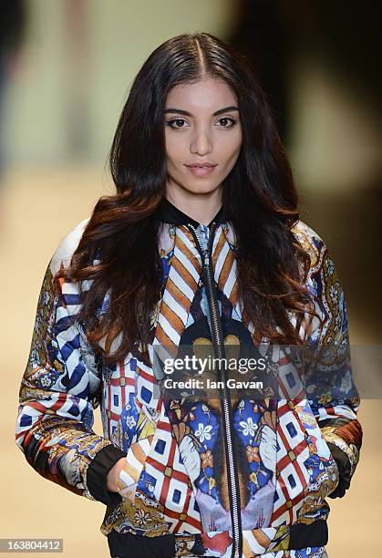 Model walks the runway during the Best of Mercedes-Benz Fashion Week Istanbul Fall/Winter 2013/14 at Antrepo 3 on March 16, 2013 in Istanbul, Turkey.