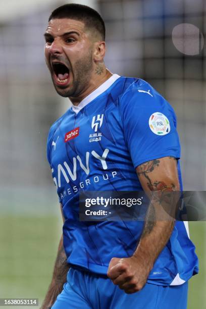 Hilal's Serbian forward Aleksandar Mitrovic reacts after a goal during the Saudi Pro League football match between Al-Ittihad and Al-Hilal at Prince...