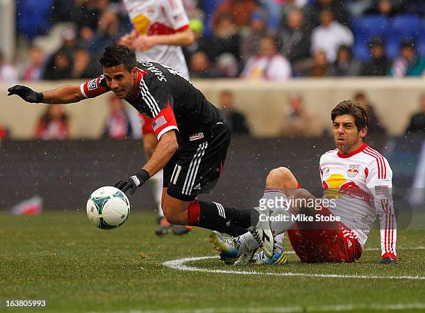 Marcelo Saragosa of D.C. United is tripped up by Juninho of New York Red Bulls at Red Bull Arena on March 16, 2013 in Harrison, New Jersey. Red Bulls...