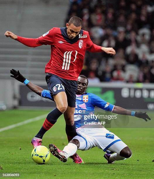 Evian's Ghanaian midfielder Mohammed Rabiu vies for the ball with Lille's French forward Ronny Rodelin during the french L1 football match Lille vs...
