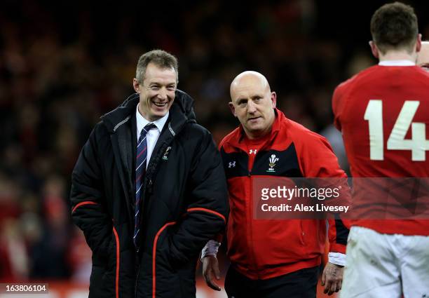 Wales caretaker coach Rob Howley, Wales defence coach Shaun Edwards and Wing Alex Cuthbert of Wales celebrate their team's victory following the...