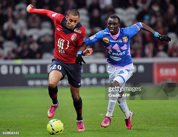 Evian's Ghanaian midfielder Mohammed Rabiu vies with Lille's French forward Ronny Rodelin during their french L1 football match Lille vs Evian on...