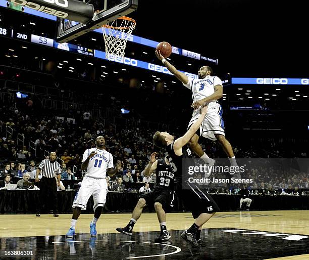 Kwamain Mitchell of the St. Louis Billikens puts up a shot past Rotnei Clarke of the Butler Bulldogs in the second half during the Atlantic 10...