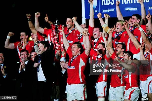 The injured Ryan Jones and Gethin Jenkins of Wales lift the Six Nations Championship trophy following their team's victory during the RBS Six Nations...