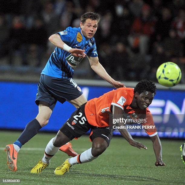 Lorient's Senegalese defender Lamine Gassama vies with Brest's French forward Benoit Lesoimier during the French L1 football match Lorient vs Brest...