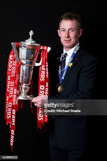 Wales caretaker coach Rob Howley poses with the Six Nations trophy following his team's victory during the RBS Six Nations match between Wales and...