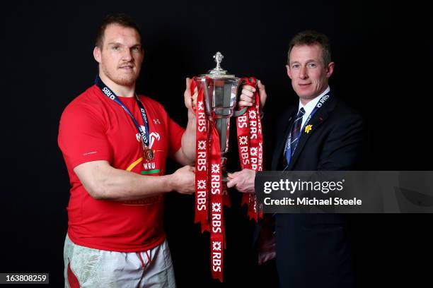 Captain Gethin Jenkins and Interim coach Rob Howley pose with the Six Nations trophy following his team's victory during the RBS Six Nations match...