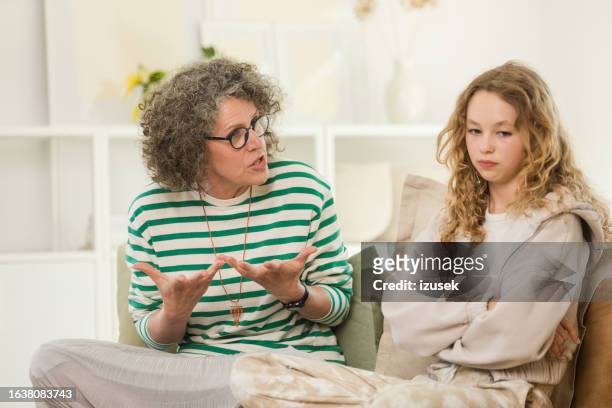 conflict between teenage girl and her mother - mom arms crossed stock pictures, royalty-free photos & images