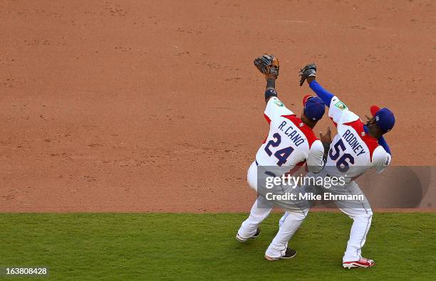 Fernando Rodney and Robinson Cano of the Dominican Republic celebrate after winning a World Baseball Classic second round game against Puerto Rico at...